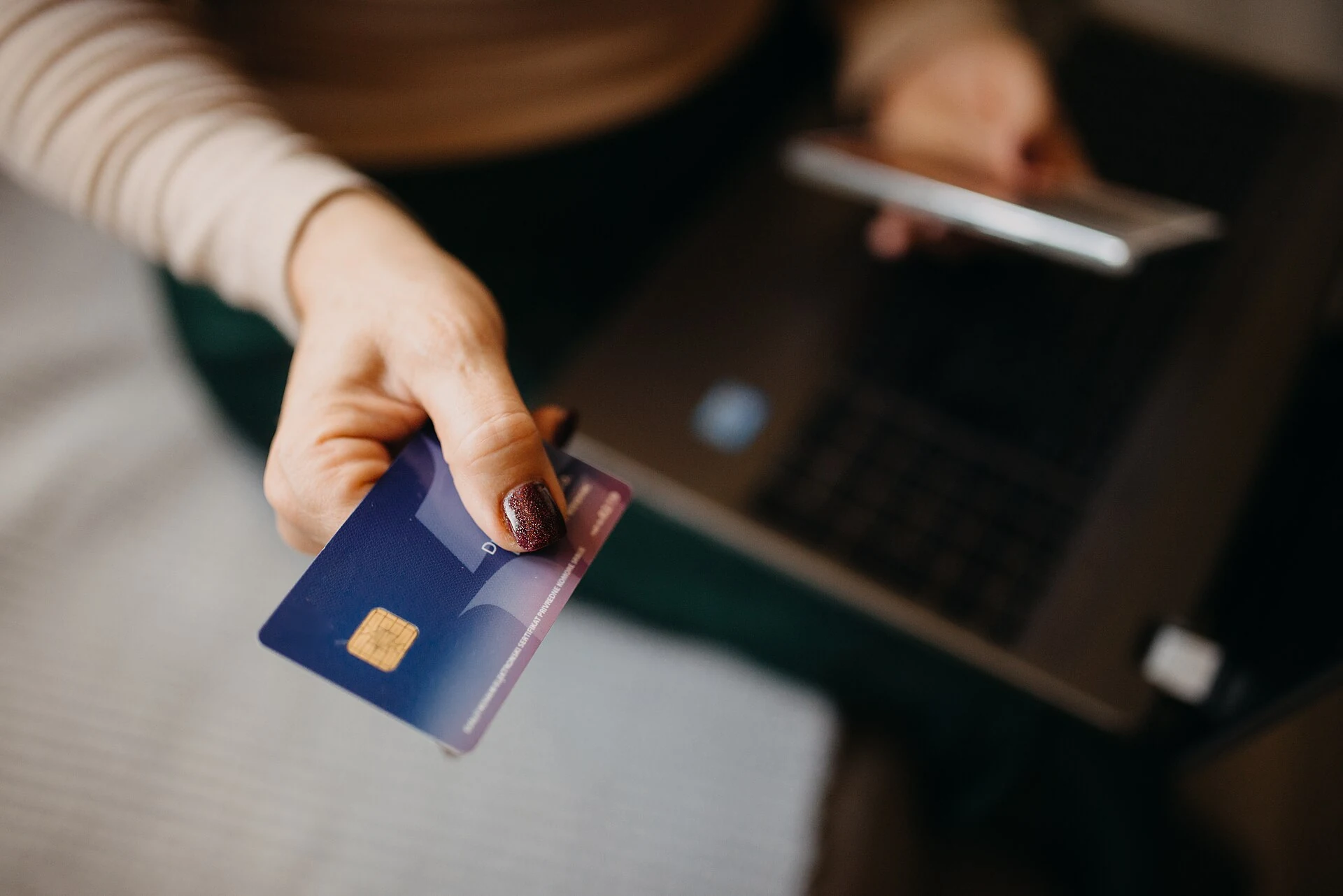 Payment card held in a hand